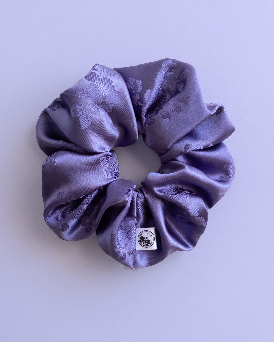 Purple Hanbok scrunchie with floral pattern on a light purple background